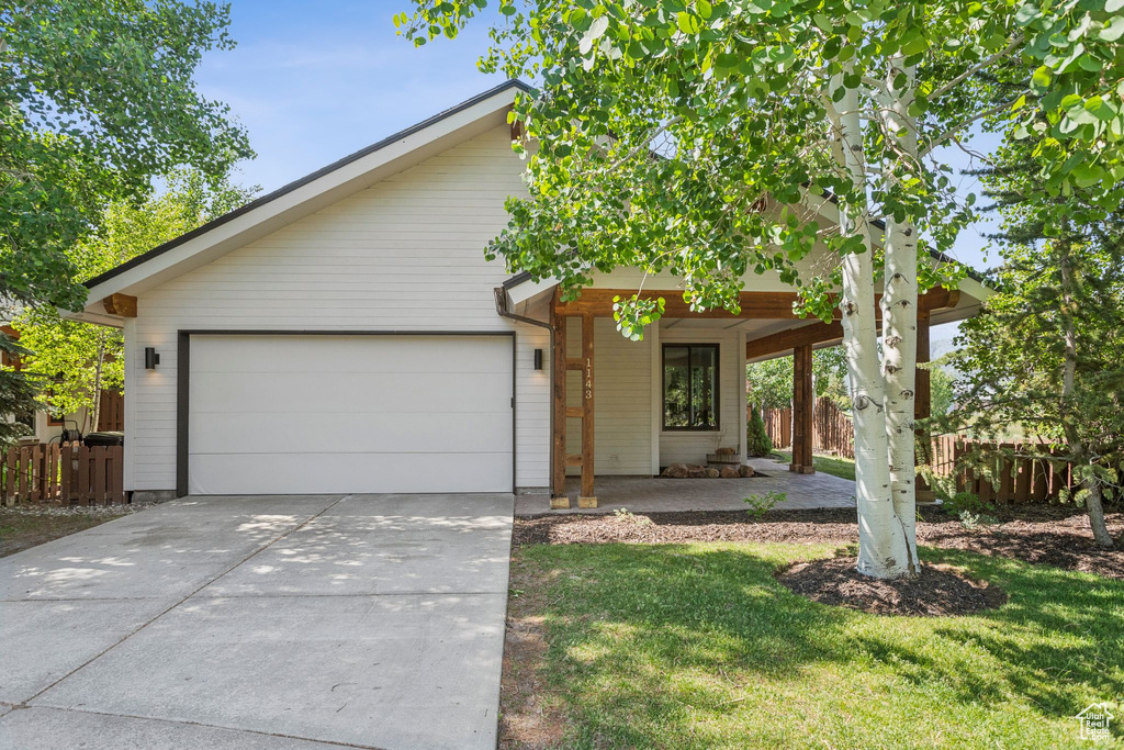 View of front facade with driveway and a garage