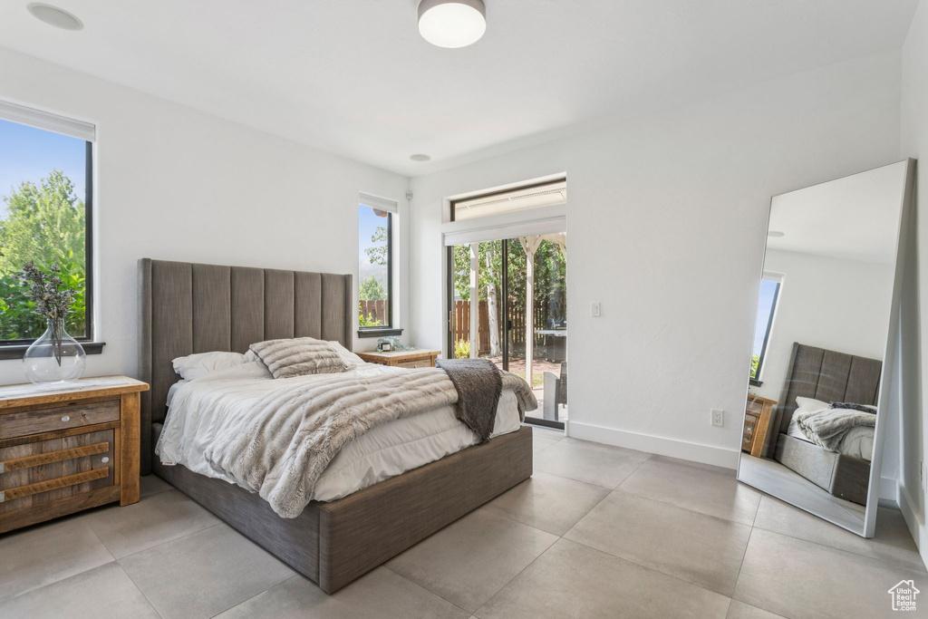 Bedroom with access to outside and baseboards