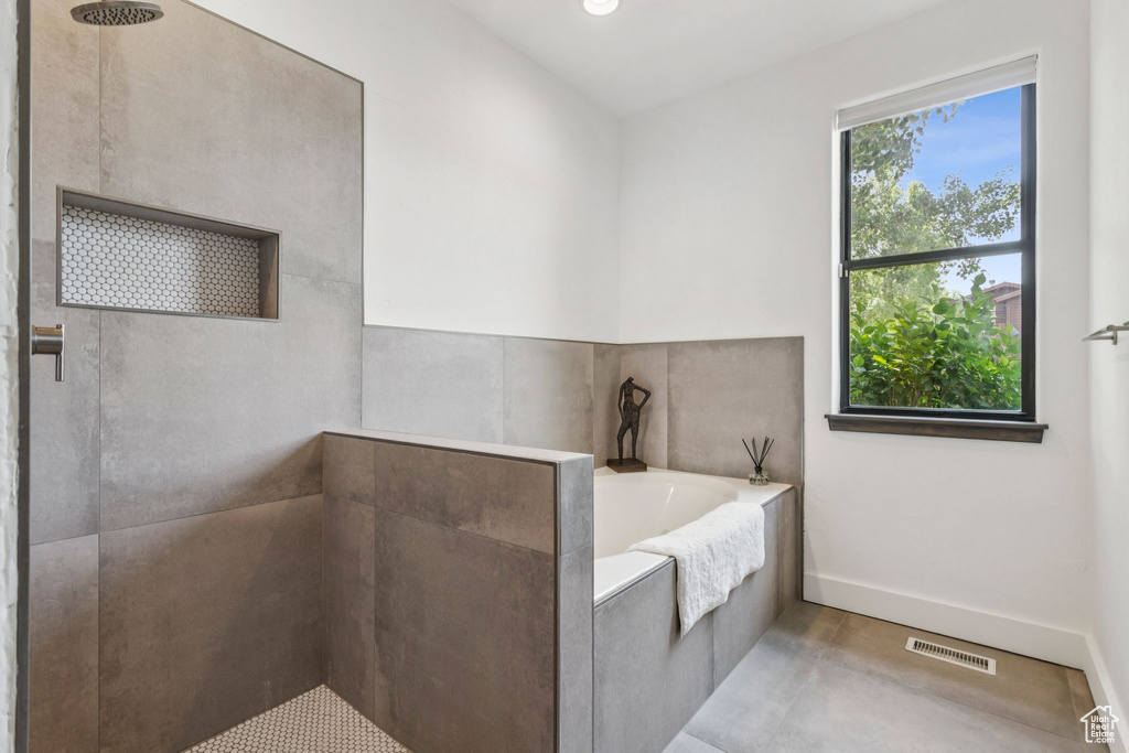 Bathroom with a bath, tiled shower, and recessed lighting