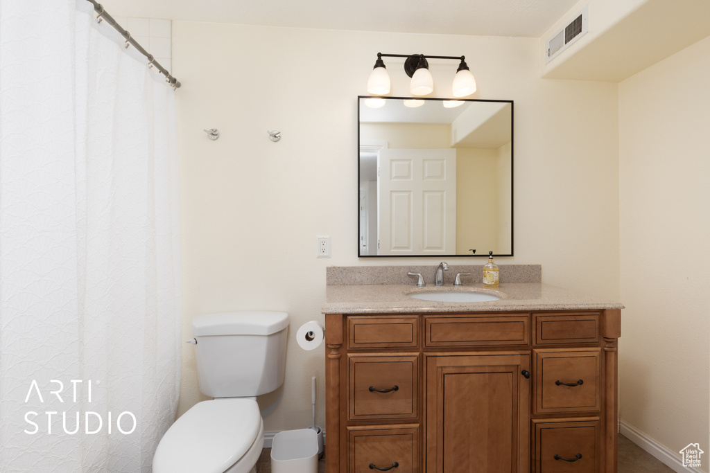 Full bathroom with vanity and toilet