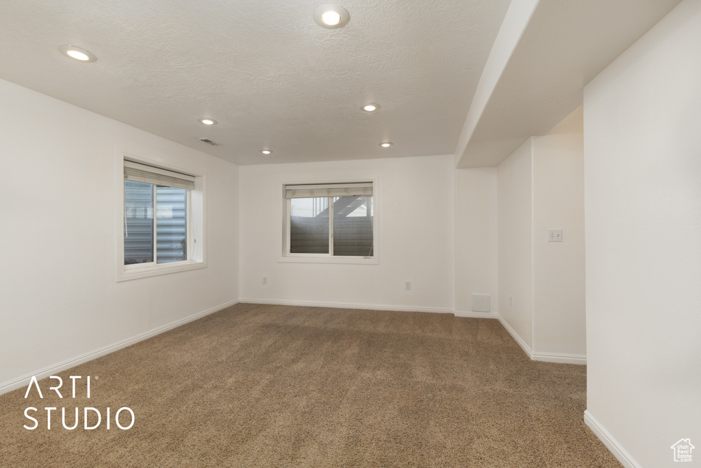 Spare room with carpet floors, recessed lighting, and a textured ceiling