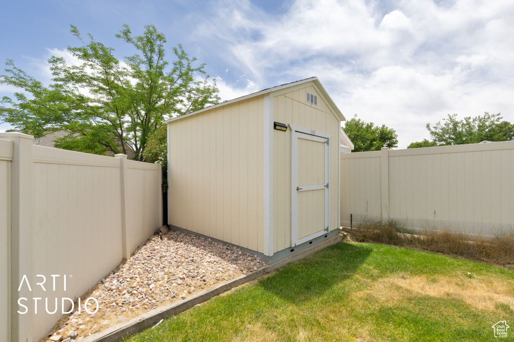 View of shed with a fenced backyard
