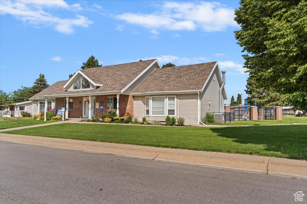 View of front of house with brick siding and a porch