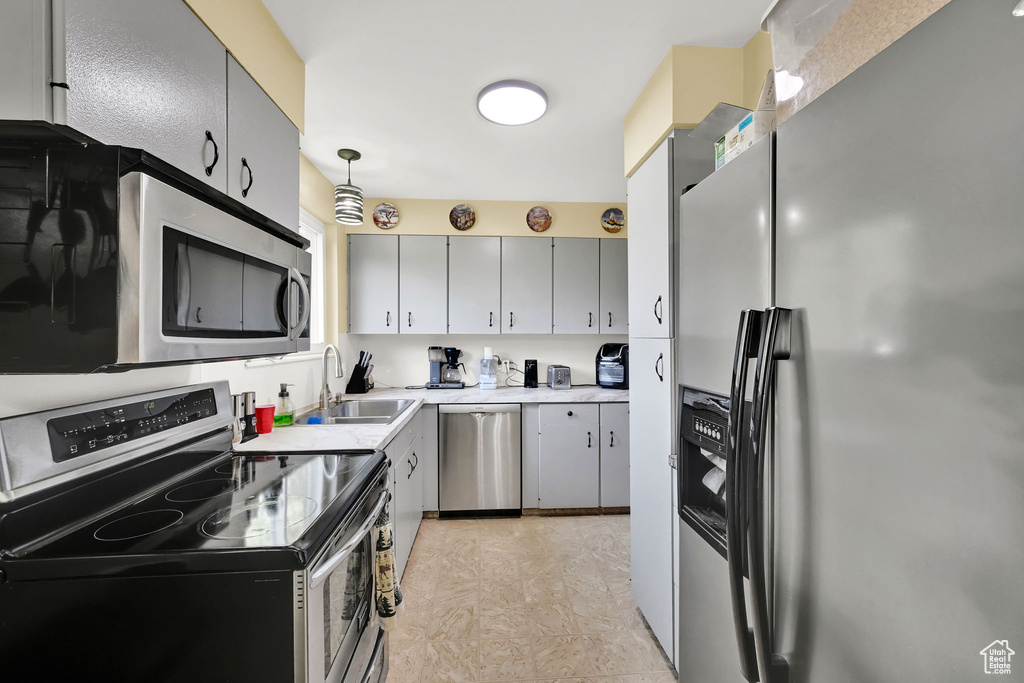 Kitchen featuring appliances with stainless steel finishes and light countertops