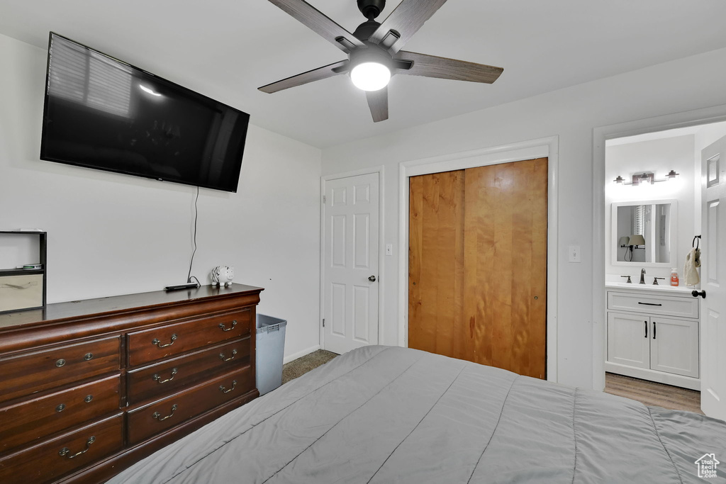 Bedroom featuring a closet, ensuite bath, and ceiling fan