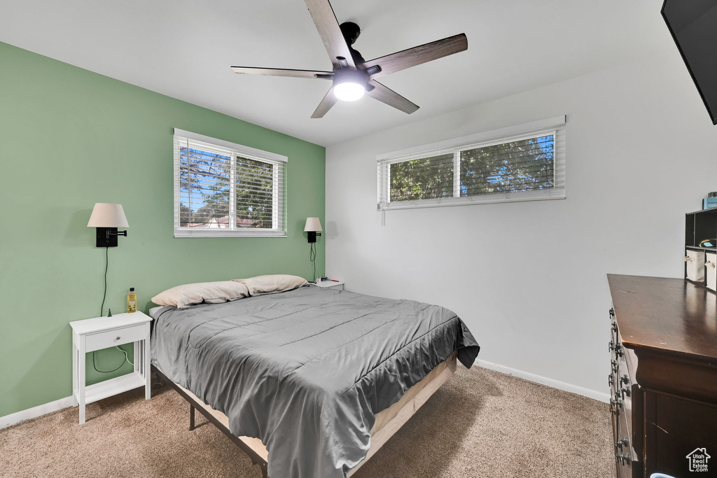 Carpeted bedroom with baseboards and ceiling fan