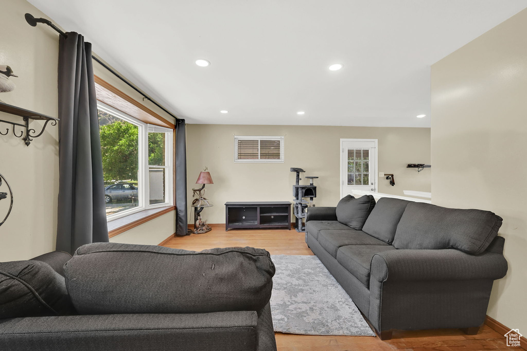 Living room with wood finished floors and recessed lighting