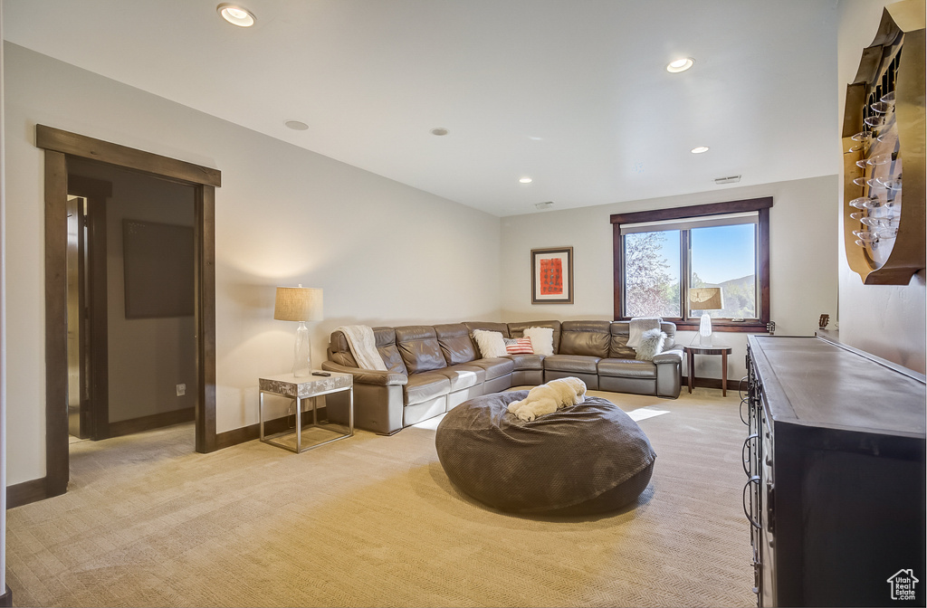 Living room featuring light colored carpet and recessed lighting