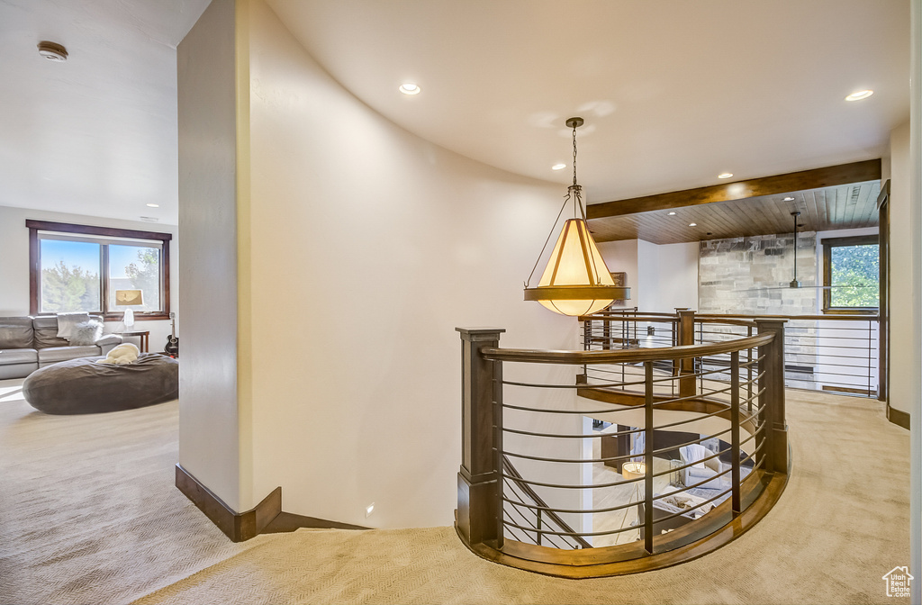 Corridor featuring an upstairs landing, carpet, plenty of natural light, and recessed lighting
