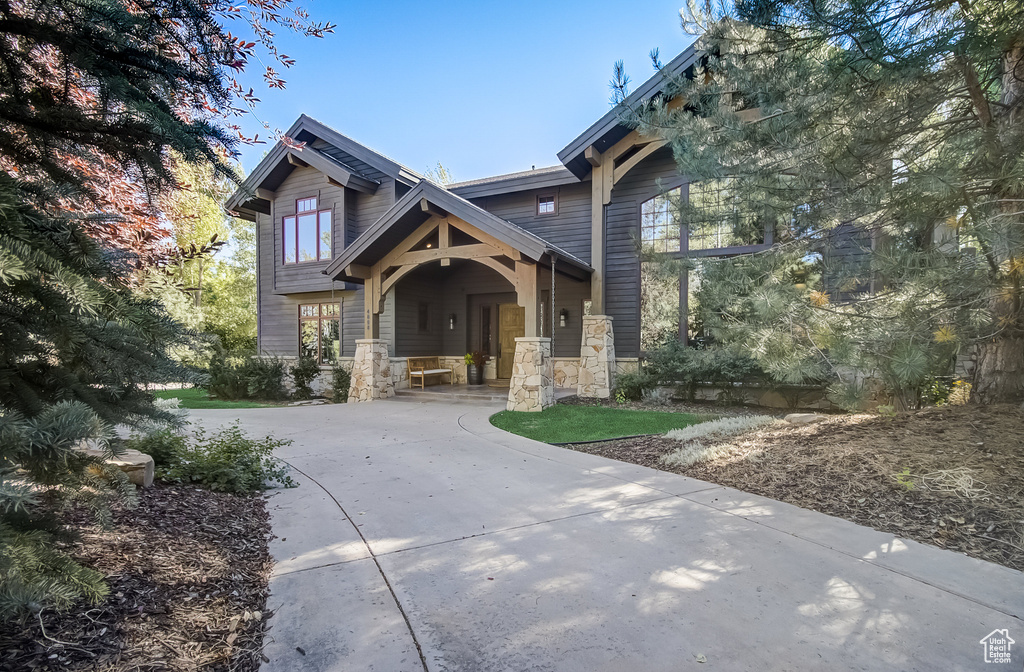 Craftsman inspired home with covered porch and stone siding