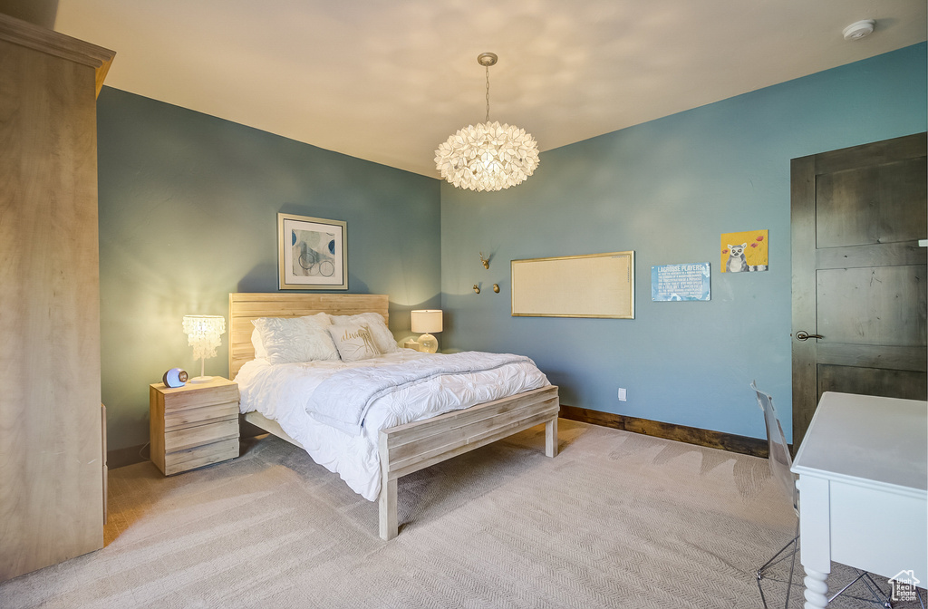 Bedroom with a chandelier and carpet floors