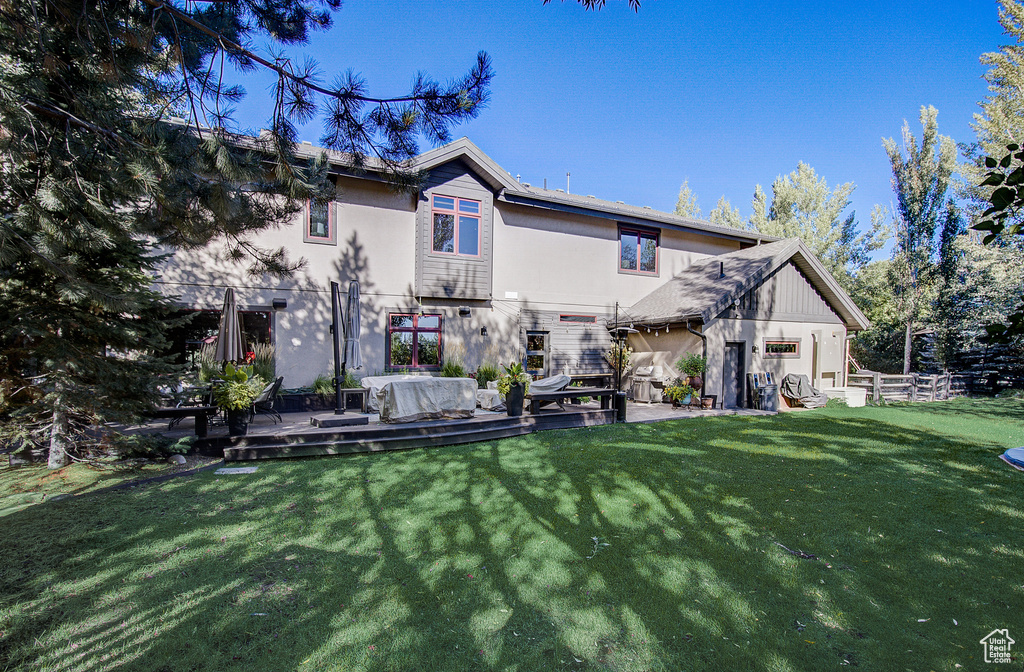 Back of property featuring stucco siding and a deck