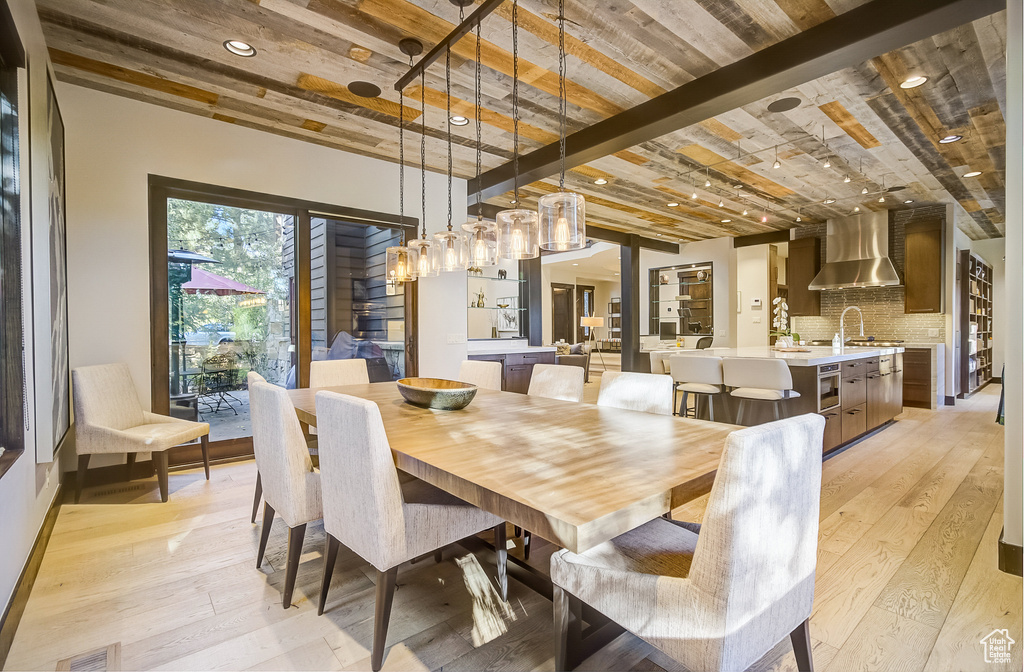 Dining area with light wood-style flooring and recessed lighting