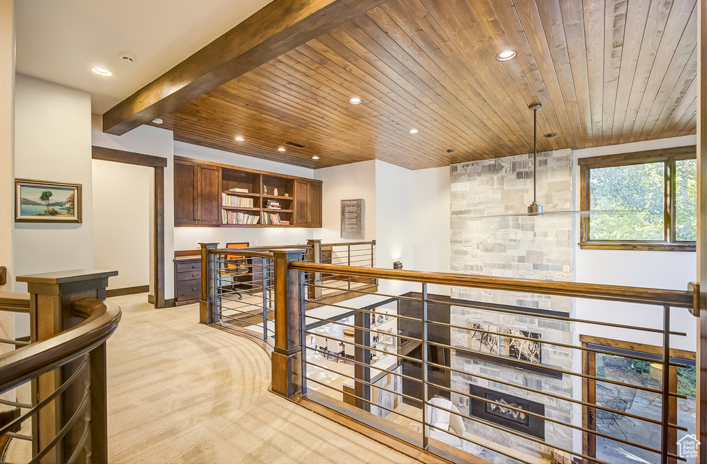Bar area with a wood ceiling with exposed beams, light carpet, and recessed lighting