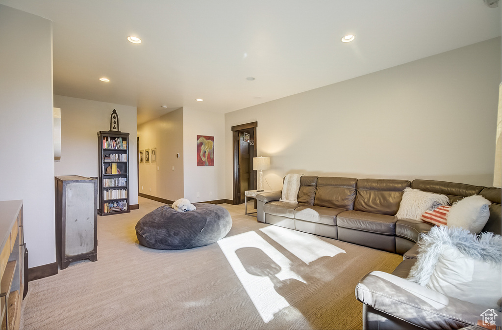Living room with recessed lighting and light carpet