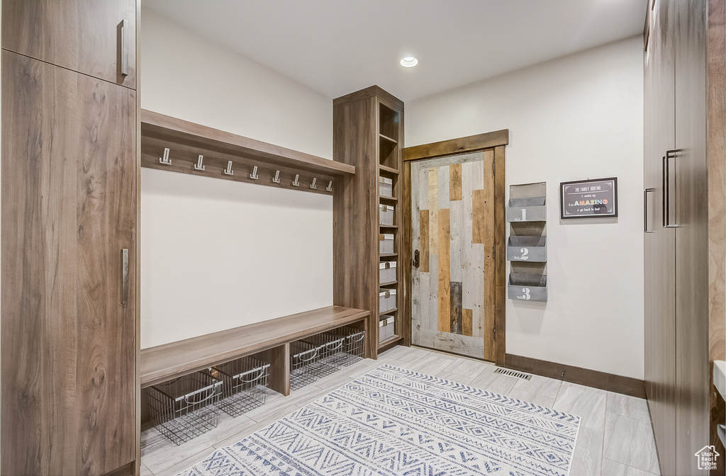 Mudroom featuring recessed lighting and wood finished floors