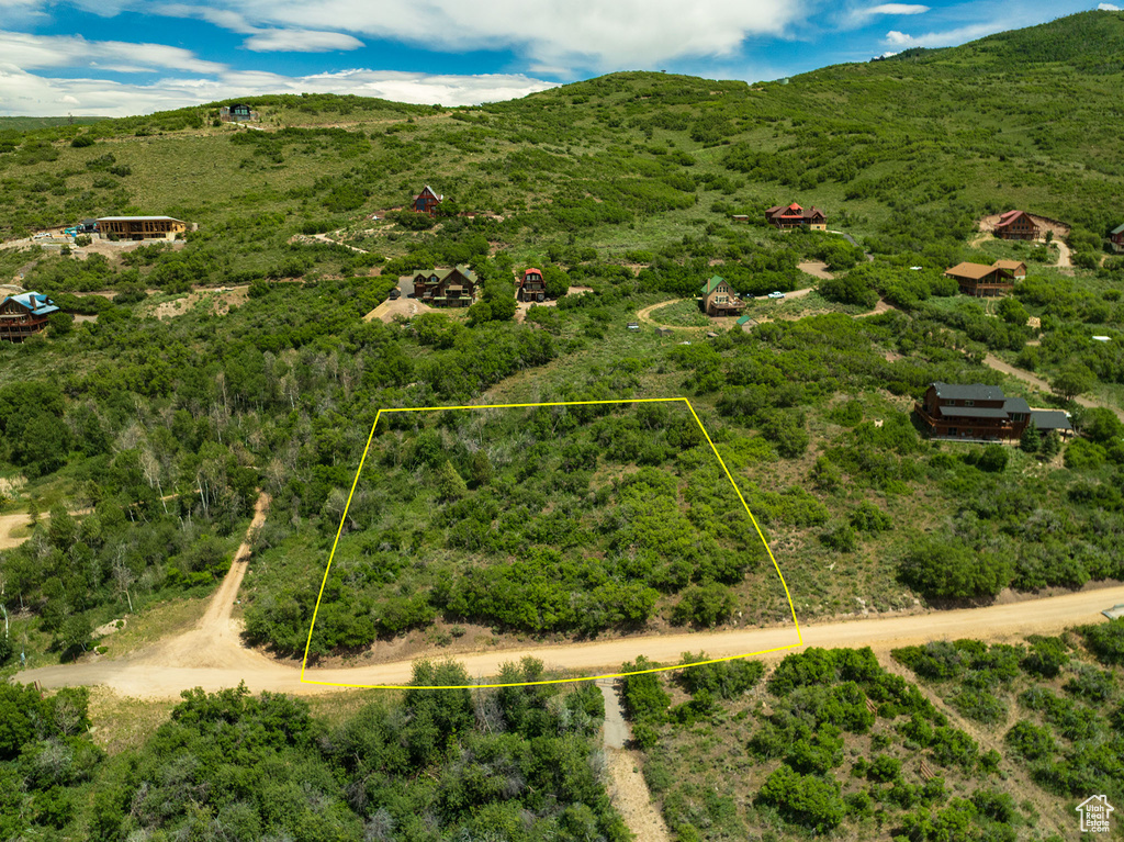 Aerial view of property and surrounding area featuring property boundaries highlighted and mountains