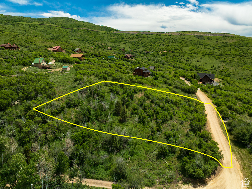 Aerial view of property's location with property boundaries highlighted and a heavily wooded area