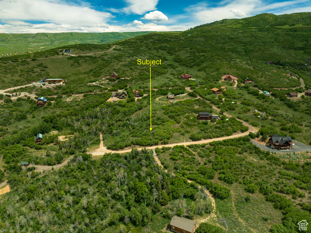 View of rural area featuring a mountain backdrop and property parcel outlined