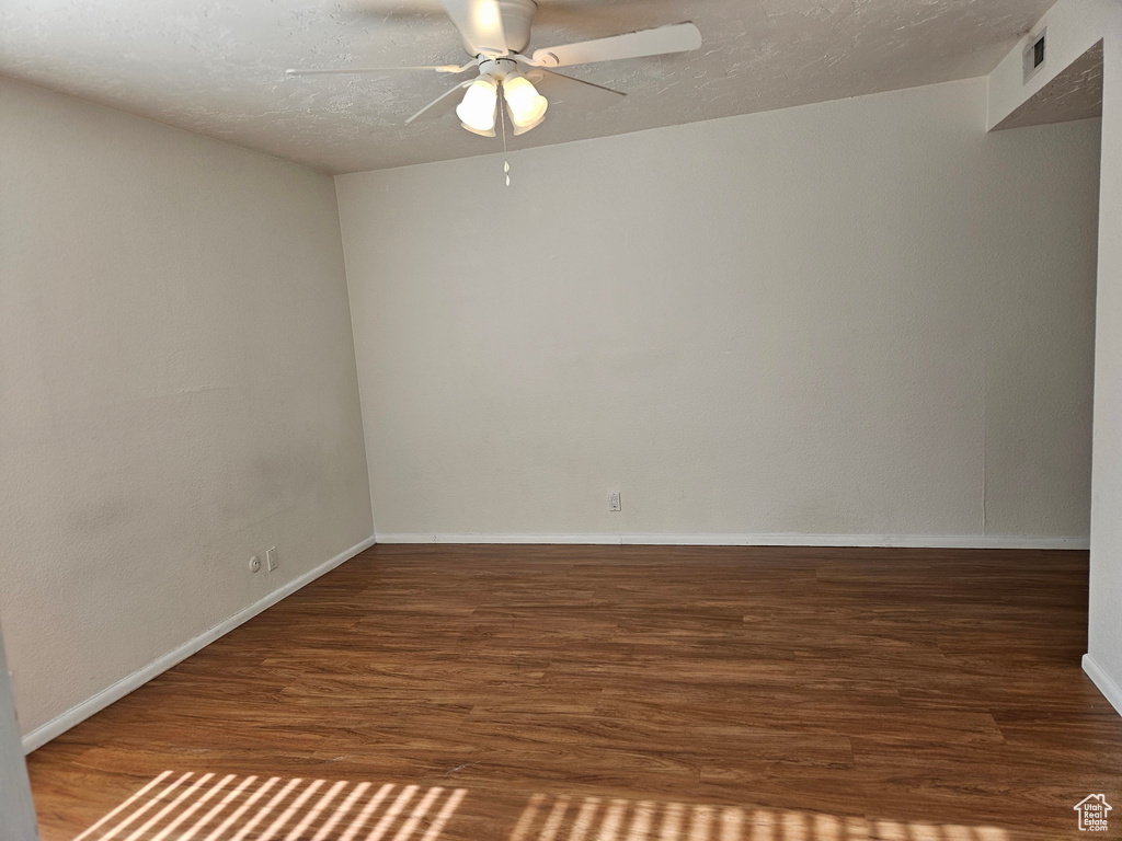 Unfurnished room featuring ceiling fan and wood finished floors