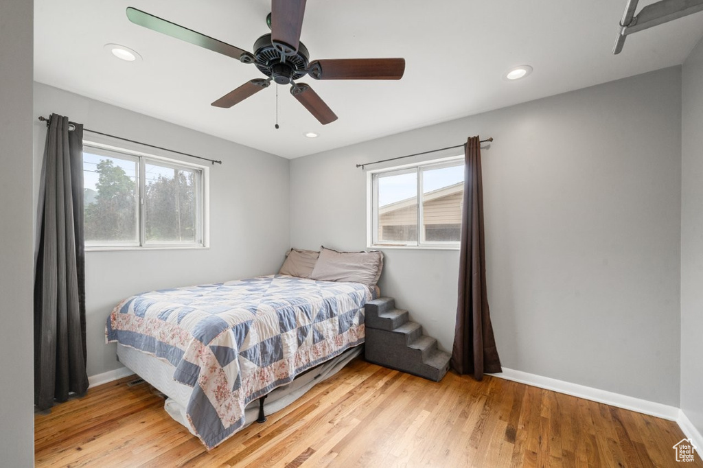 Bedroom with light wood-style flooring, recessed lighting, and a ceiling fan
