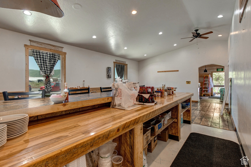 Kitchen featuring recessed lighting, arched walkways, ceiling fan, and vaulted ceiling