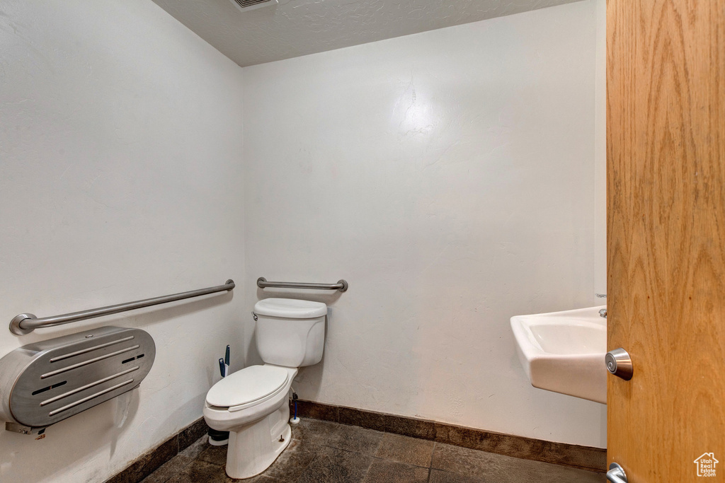 Bathroom with toilet and baseboards