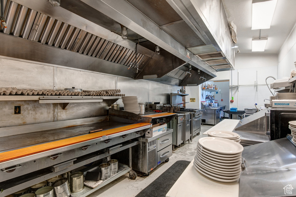 Kitchen with concrete flooring and high end range