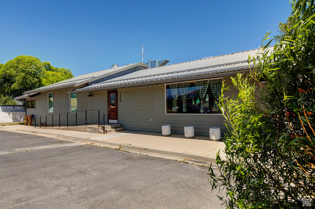 View of front of house with a metal roof