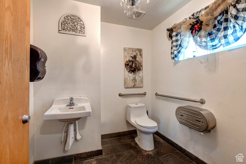 Bathroom with toilet and baseboards