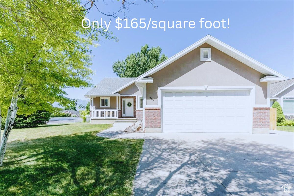 Ranch-style house with brick siding, an attached garage, concrete driveway, a front yard, and covered porch