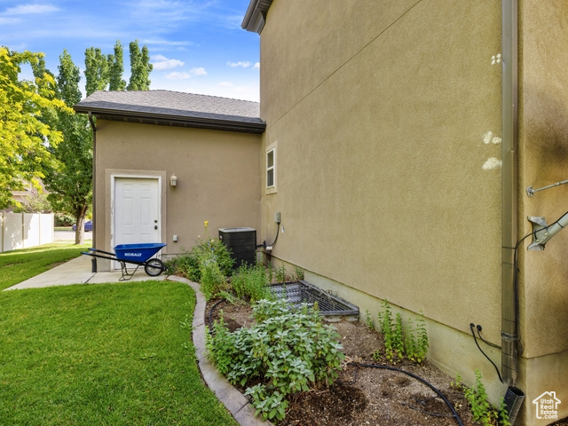 View of property exterior with stucco siding and a patio