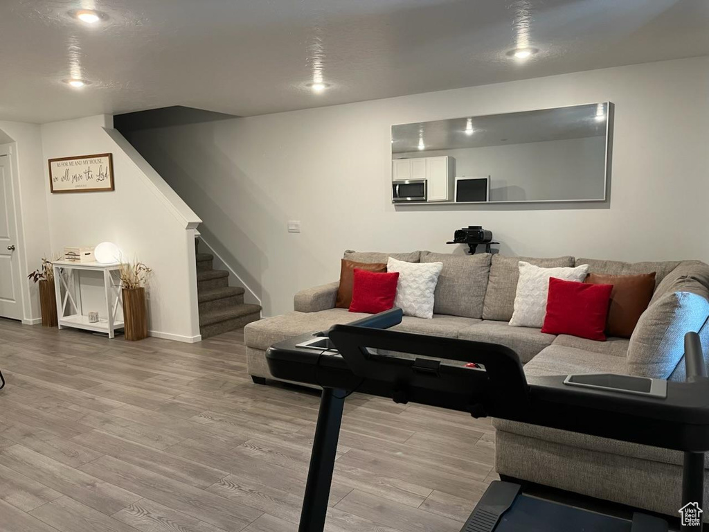 Living room featuring wood finished floors and stairway