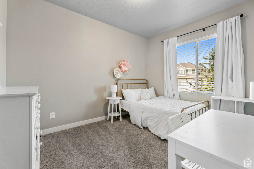 Carpeted bedroom featuring baseboards