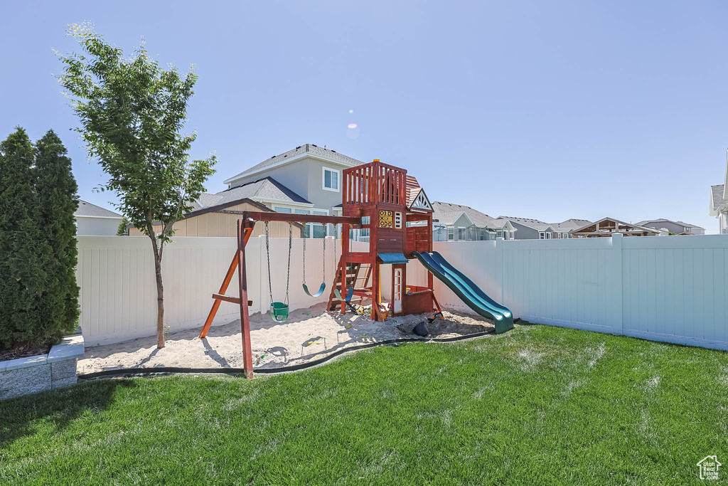 View of playground with a fenced backyard