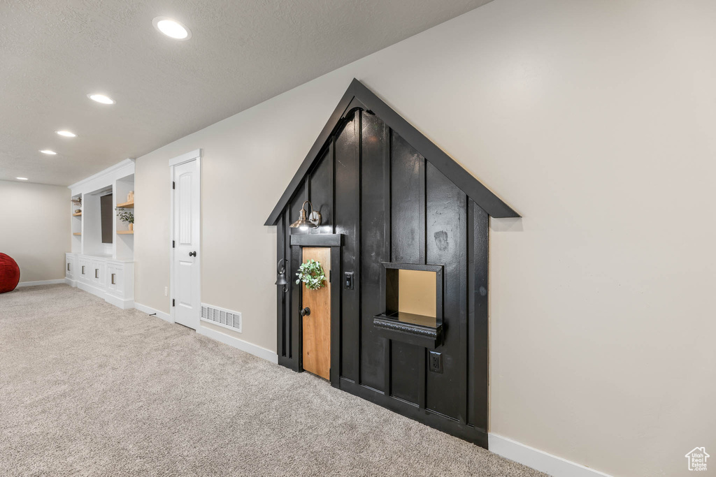 Bonus room with carpet and recessed lighting