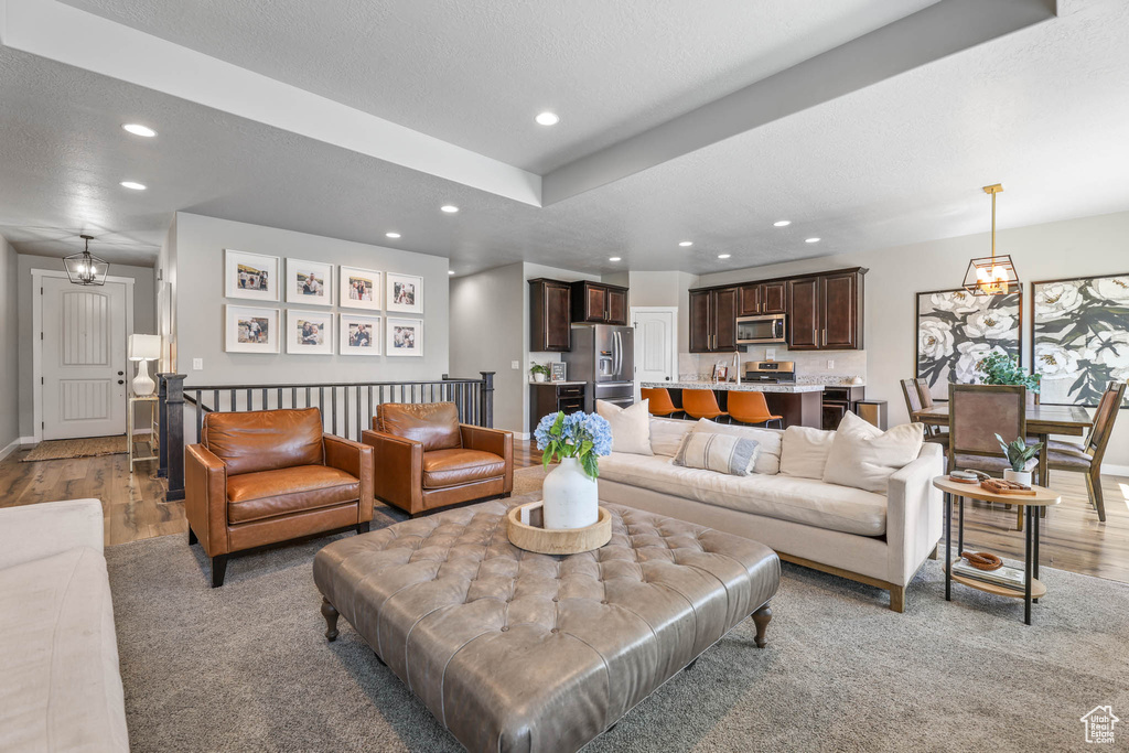 Living room with recessed lighting and light wood finished floors