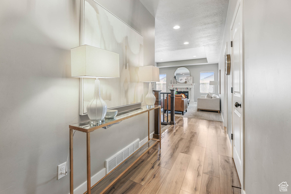 Hall featuring light wood-style flooring and recessed lighting