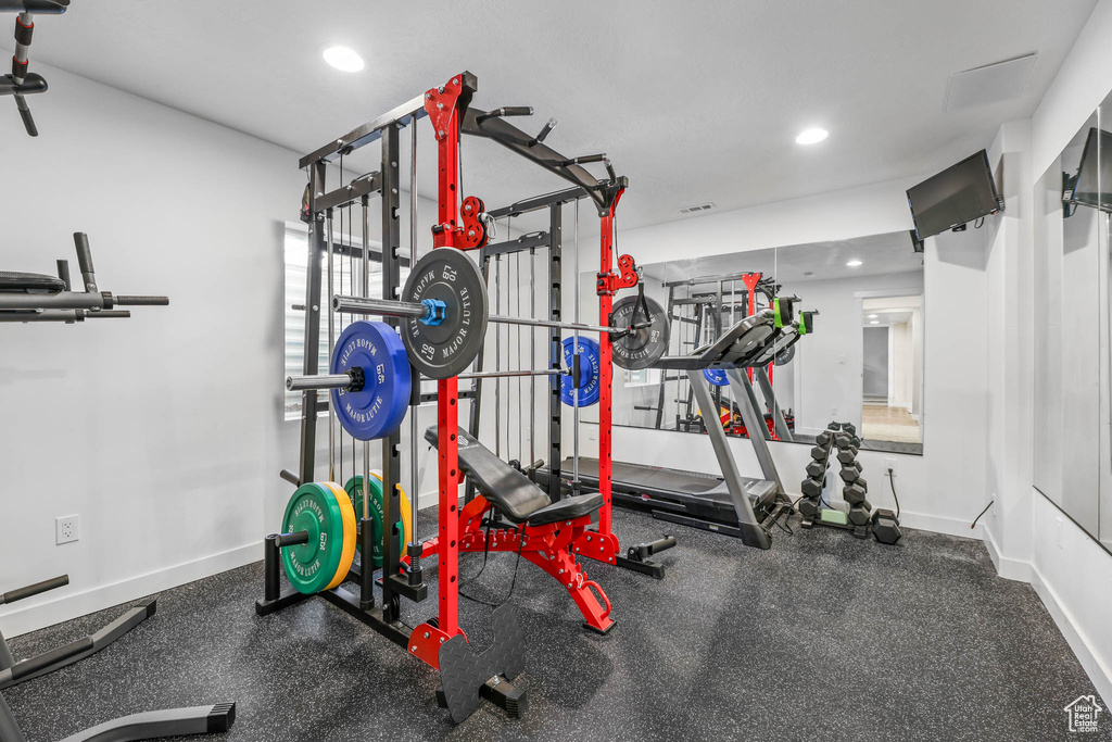 Workout room featuring recessed lighting