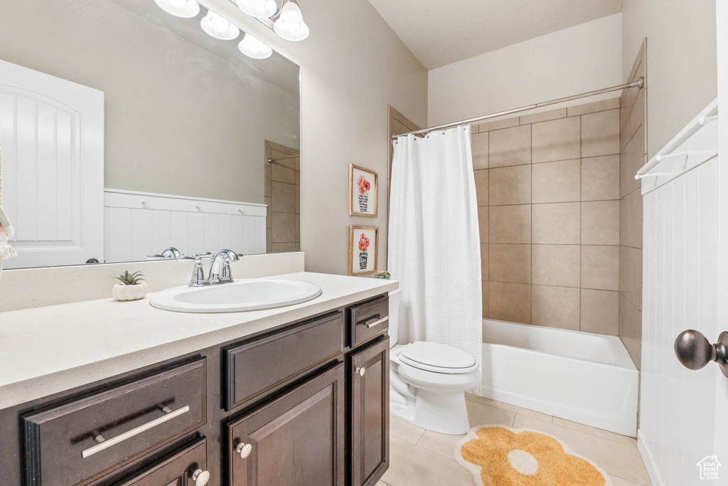 Full bathroom featuring vanity, tile patterned flooring, and shower / bath combo with shower curtain