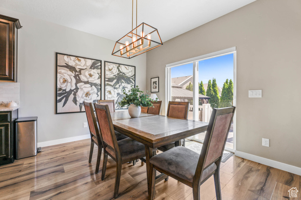 Dining area with a chandelier and light wood finished floors