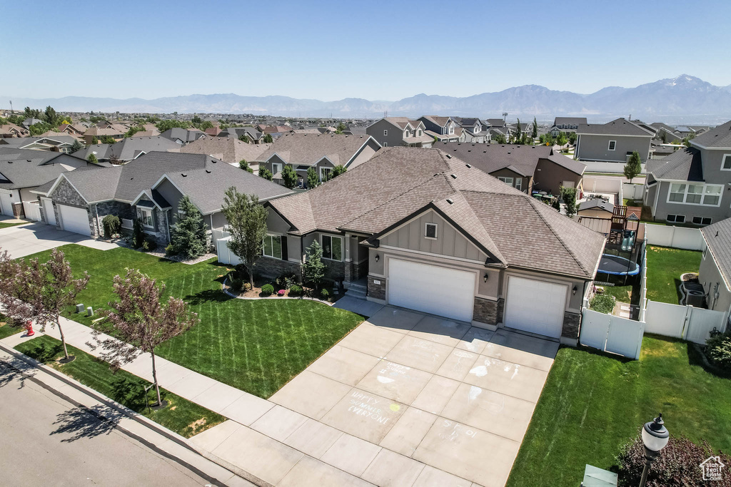Single story home with a residential view, board and batten siding, driveway, and an attached garage