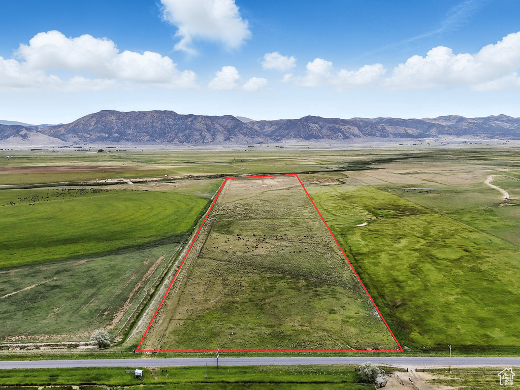 Aerial view of sparsely populated area with a mountainous background and property boundaries highlighted