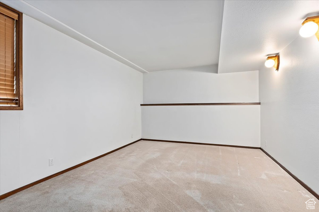 Carpeted empty room with baseboards