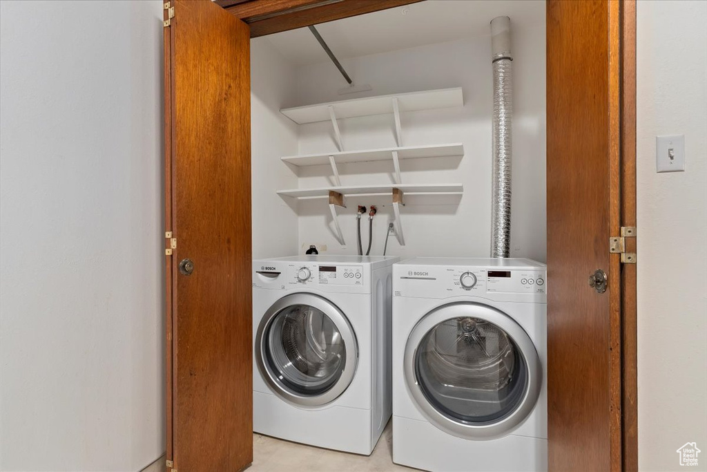 Laundry room with washer and clothes dryer