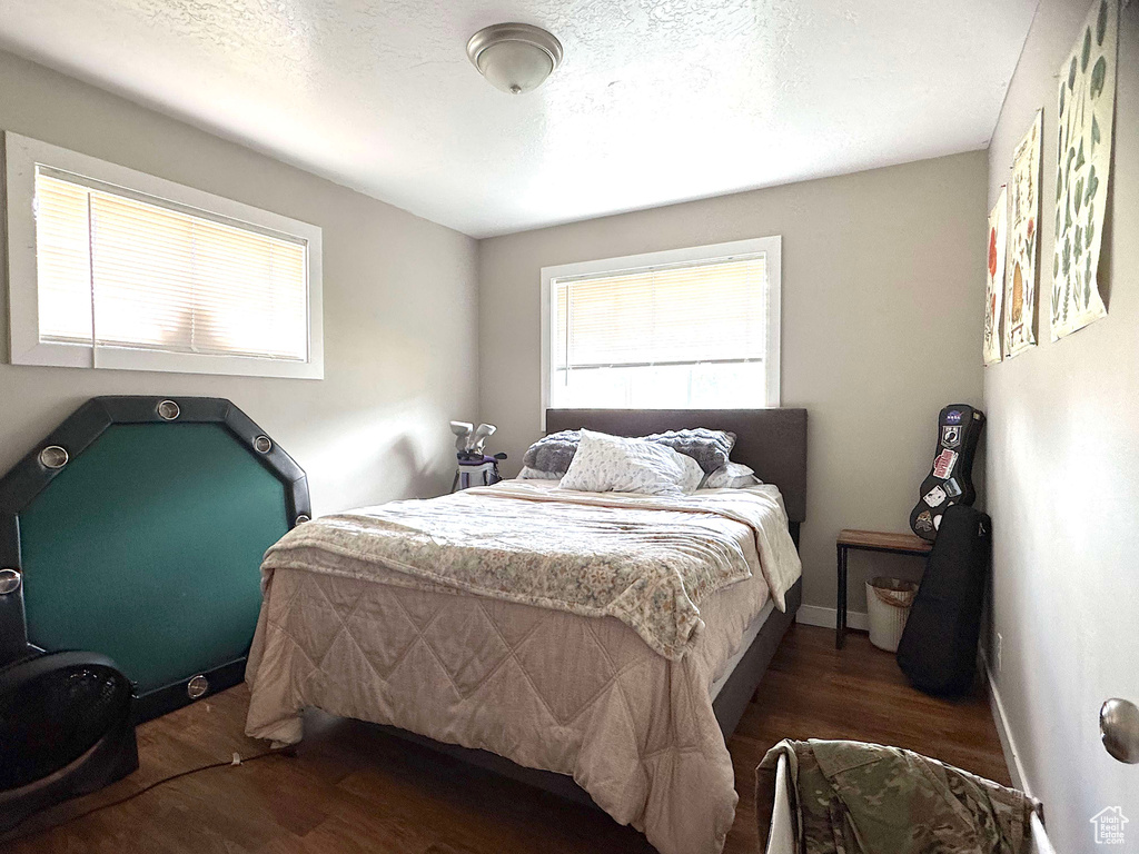 Bedroom featuring wood finished floors and baseboards