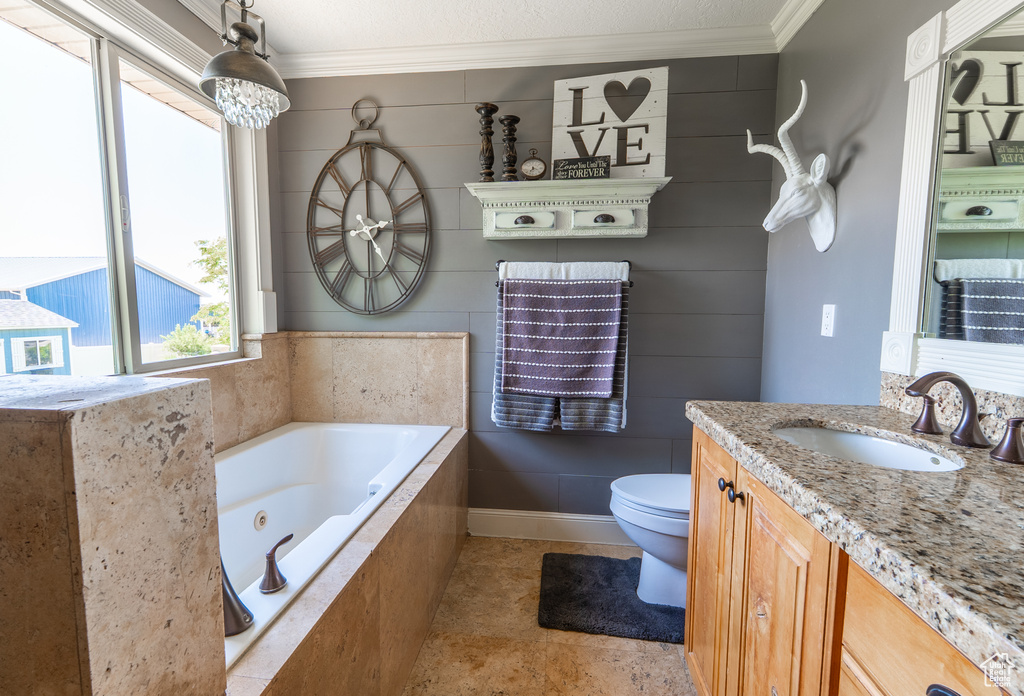 Bathroom featuring crown molding, vanity, a whirlpool tub, and tile patterned floors