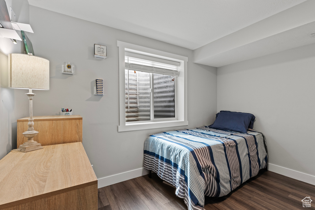 Bedroom featuring baseboards and wood finished floors