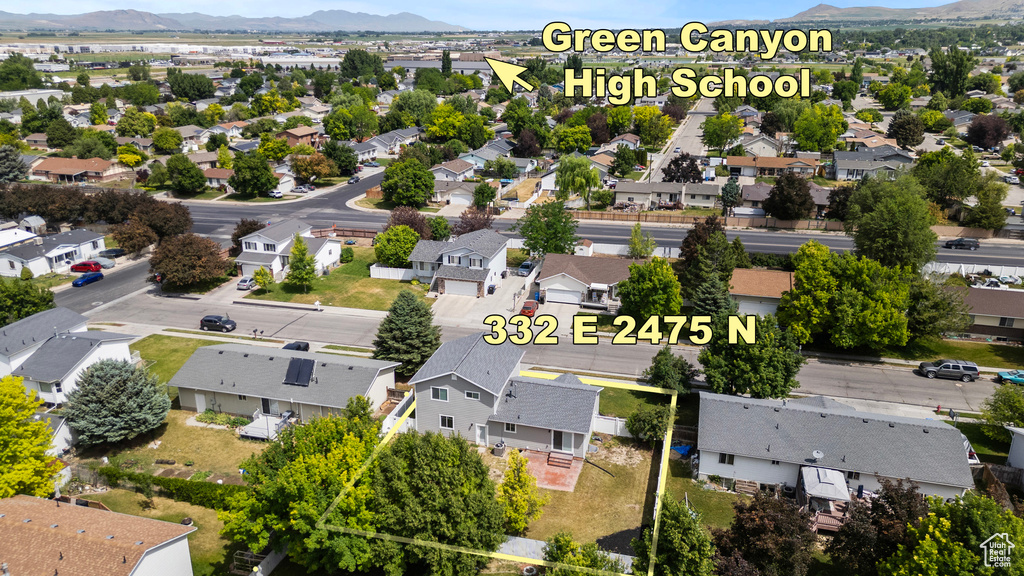Aerial perspective of suburban area with a mountainous background