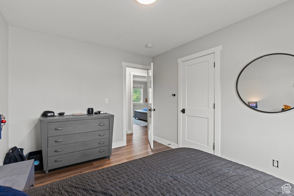 Bedroom with dark wood-type flooring